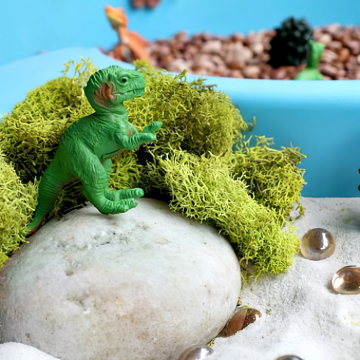 toy dinosaur on a water table as sensory bins for preschoolers