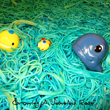 pasta sea exploration - ocean animal toys in a sea of dyed noddle pasta