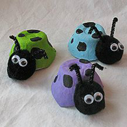 Three ladybugs out of egg carton - green ladybug, blue lady bug, violet lady bug