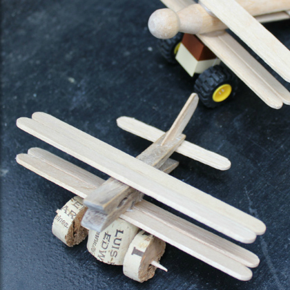 airplane toy made of popsicles, wine cork, and clothespin as paper plane crafts for kids