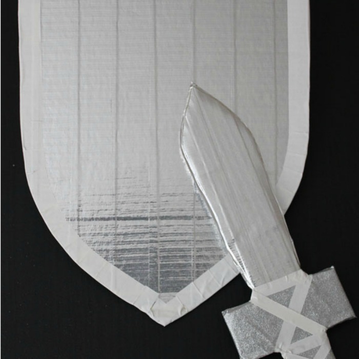 DIY Gray Sword and Shield for a Slumber Party made of silver duct tape, glitter duck tape, colored duck tape and scissors