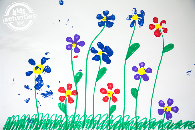 water bottle art idea from Kids Activities Blog - shown is the finished kid painting of flowers made with the bottom of a water bottle
